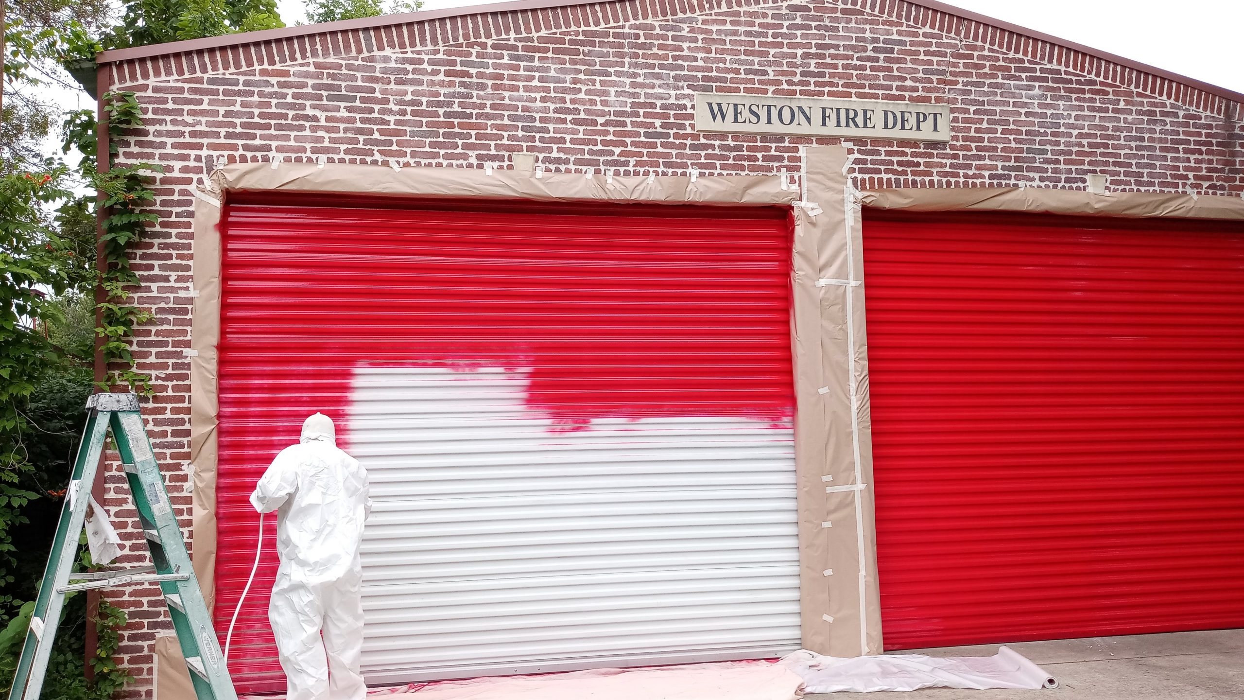 A man painting a fire station
